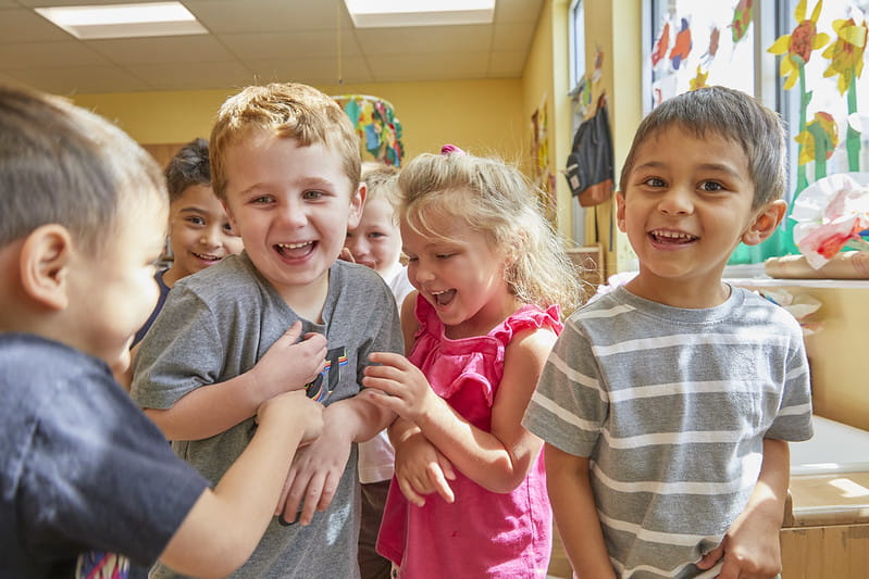 Kids laughing in a classroom